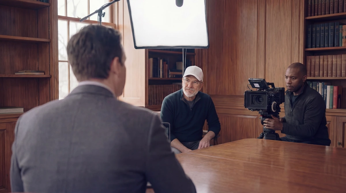 Behind the scenes of a client interview, camera operator in foreground